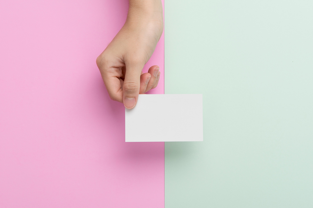 Hand giving blank business card